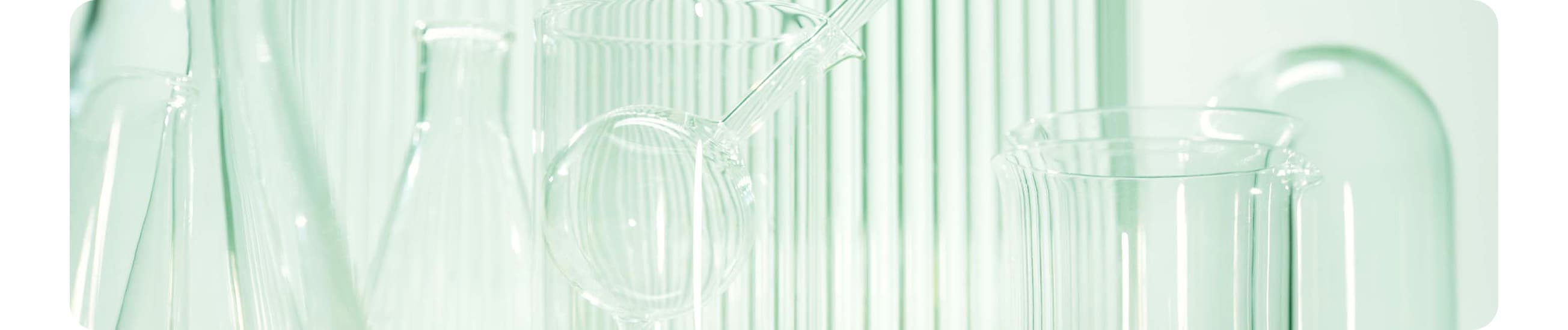 Background image containing selection of dermatologist glass vials in different shapes